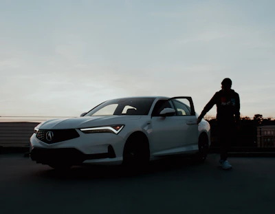 Close-up of a cheerful driver unlocking a small urban vehicle in the morning light.