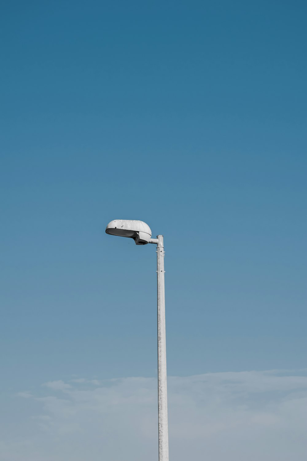 a light post with a satellite dish on top