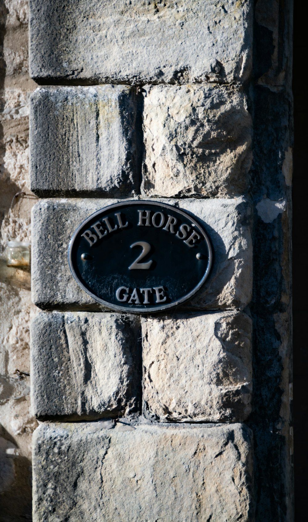 a sign on a stone wall