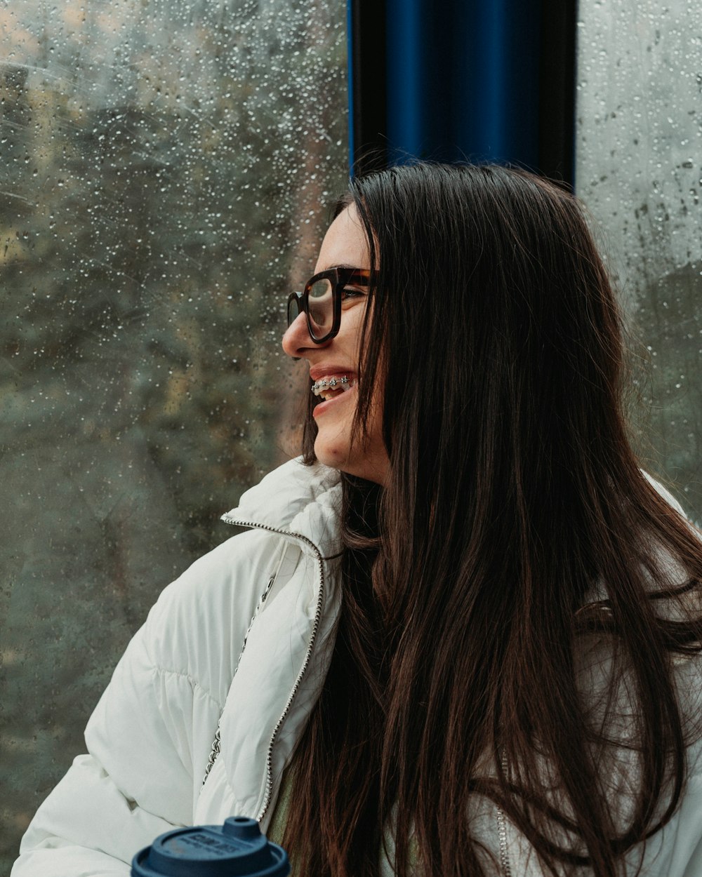 a person with long hair and glasses