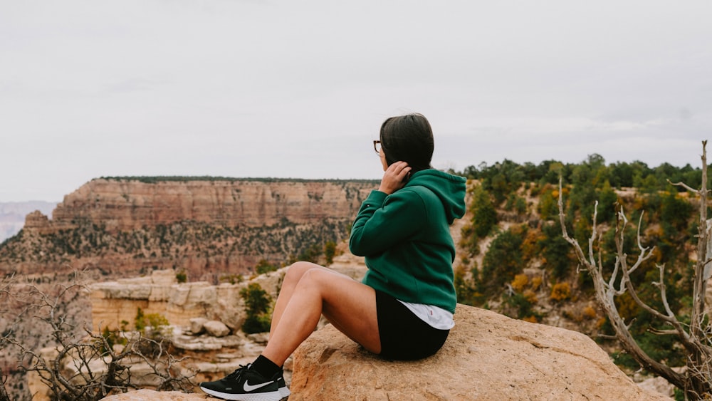 a man sitting on a rock