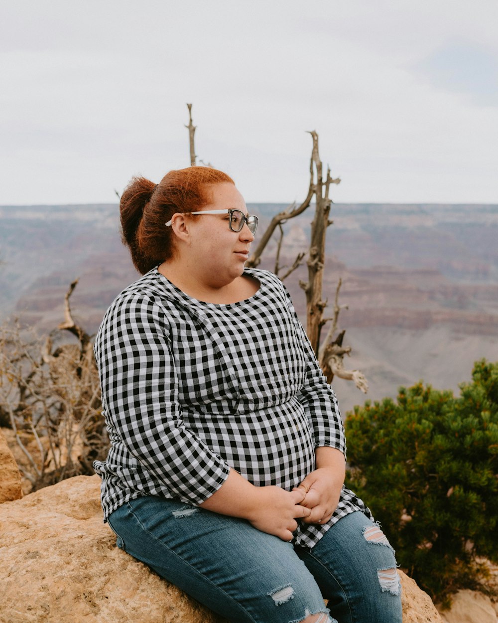 a person sitting on a rock