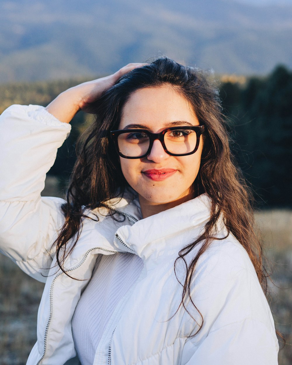 a woman with long hair and glasses