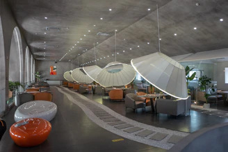 a room with a large glass ceiling and a round table with chairs