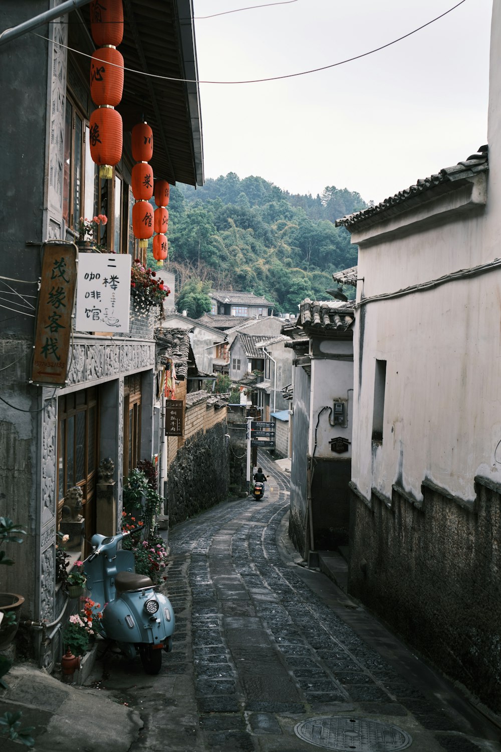 a narrow street with buildings and trees