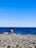 A couple relaxing on a sunbed by the ocean.