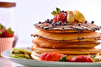 a stack of pancakes with fruit on top