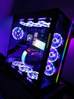 A compact CPU tower with sleek green LED accents on a minimalist desk.