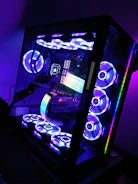 A compact CPU tower with sleek green LED accents on a minimalist desk.