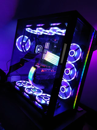 A sleek gaming desktop with vibrant RGB lighting glowing in a dark room