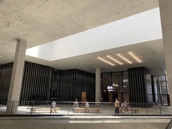 A cozy, modern cinema lobby bathed in soft natural light, inviting visitors to enjoy a welcoming film experience.