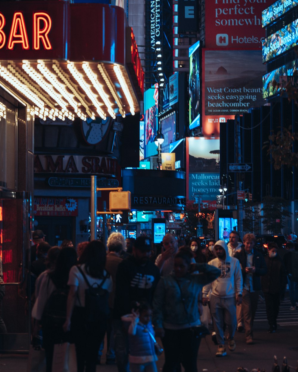 a crowd of people walking through a city