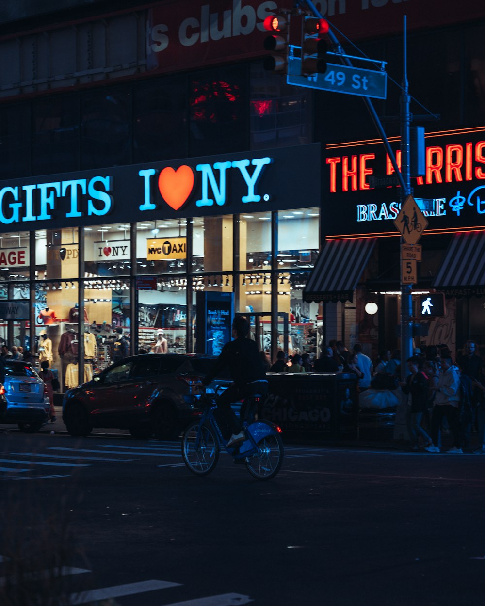 a person riding a bicycle in front of a store