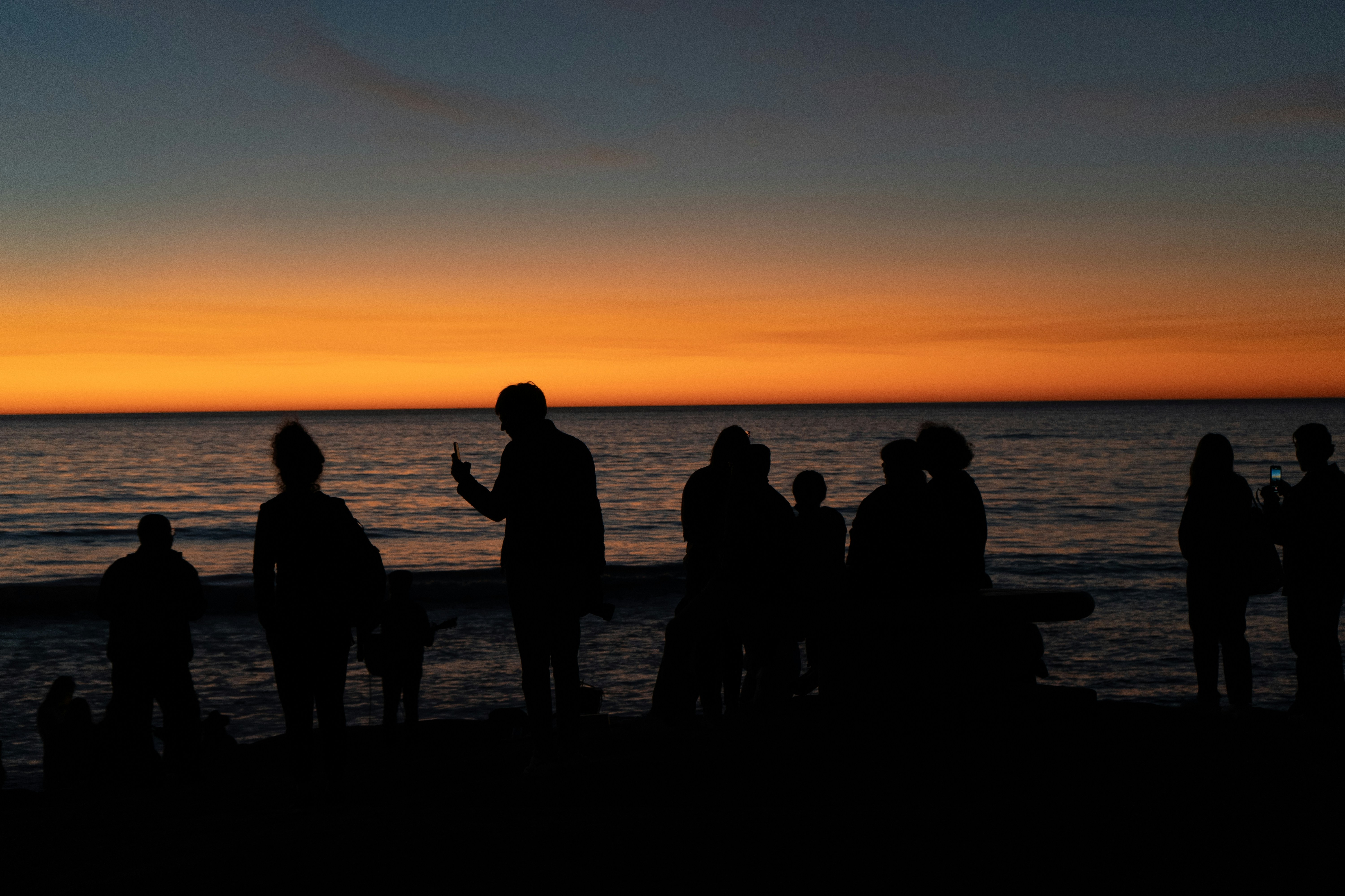 Family gathering for a scattering ceremony at sunset - human cremation