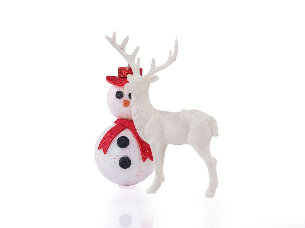 a white reindeer with a red scarf