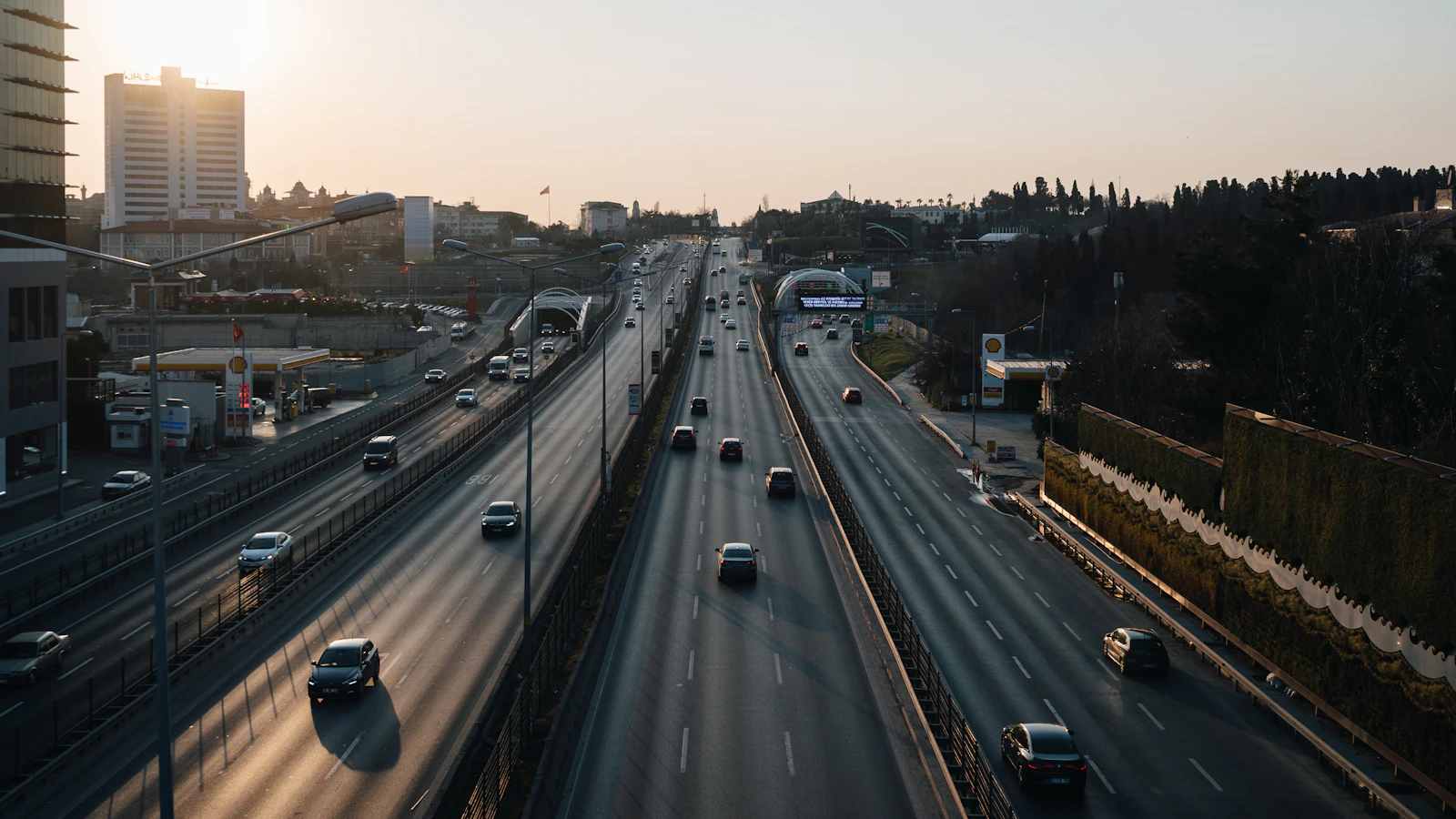 Cars filling both directions of an Istanbul arterial road near sunset