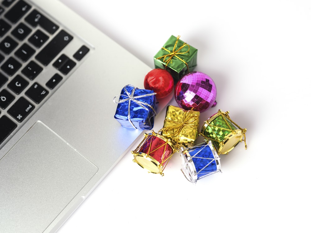 a group of colorful objects next to a laptop