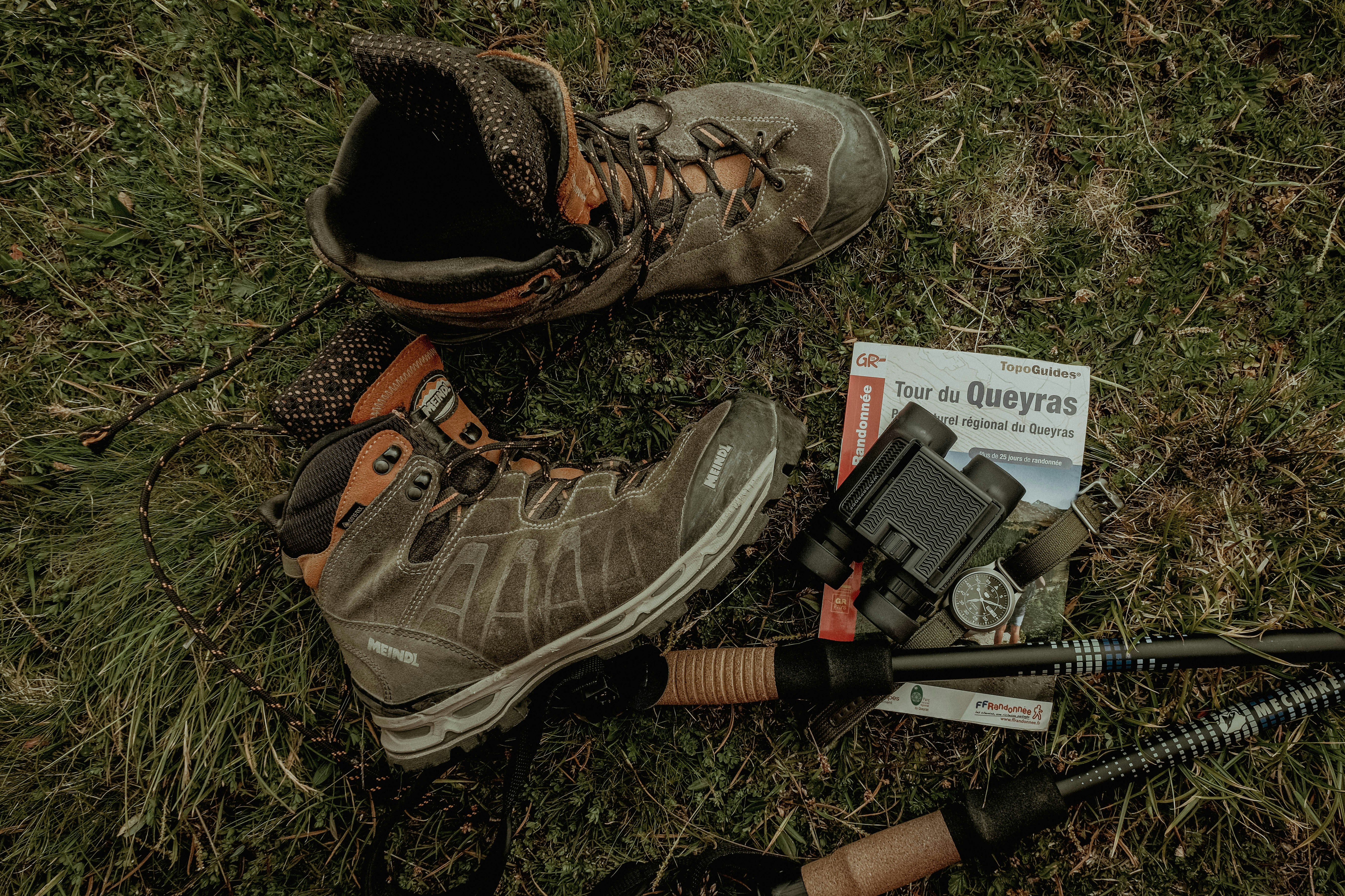 a pair of boots and a gun on the ground