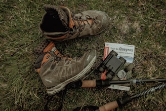 a pair of boots and a gun on the ground