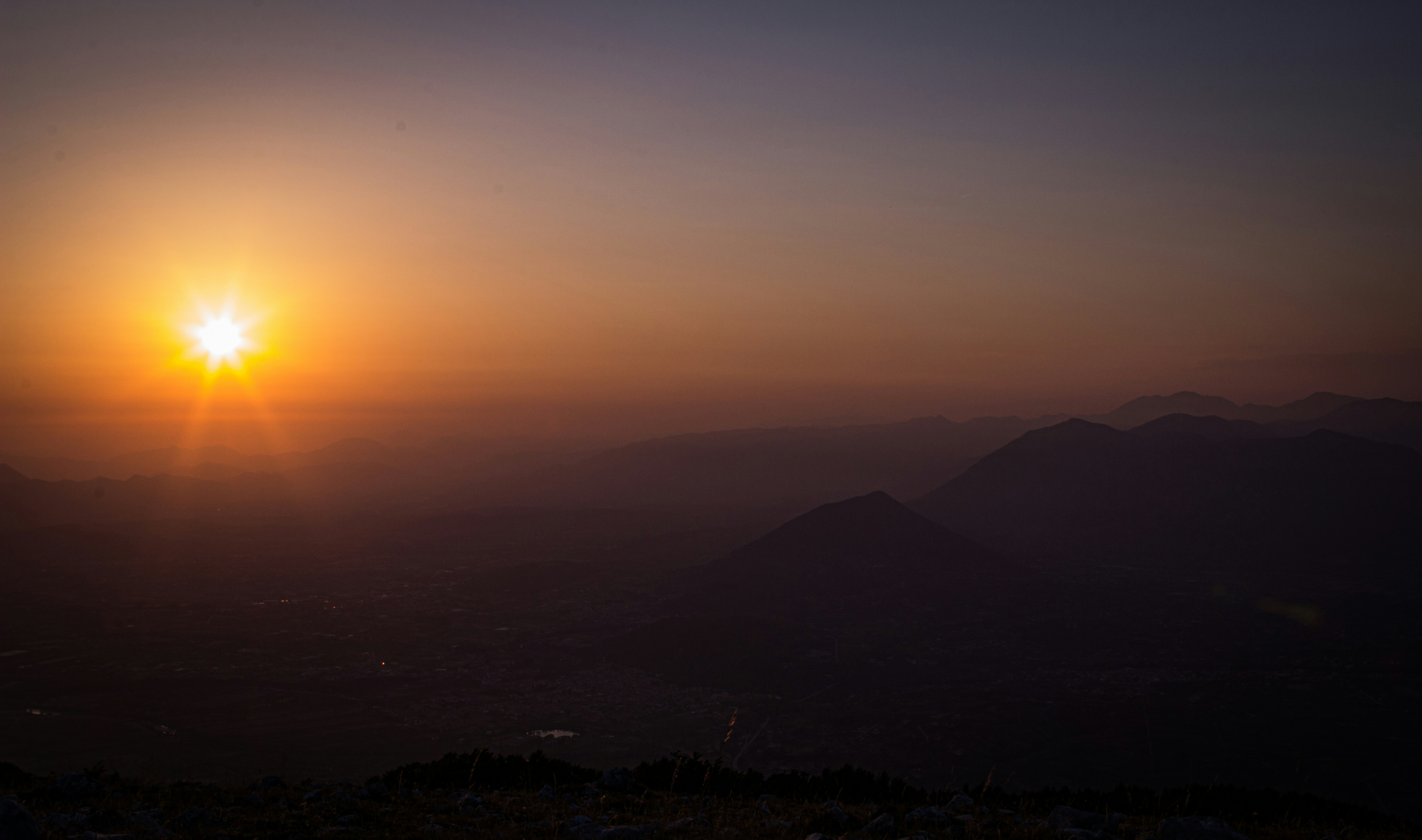 a sunset over a mountain range
