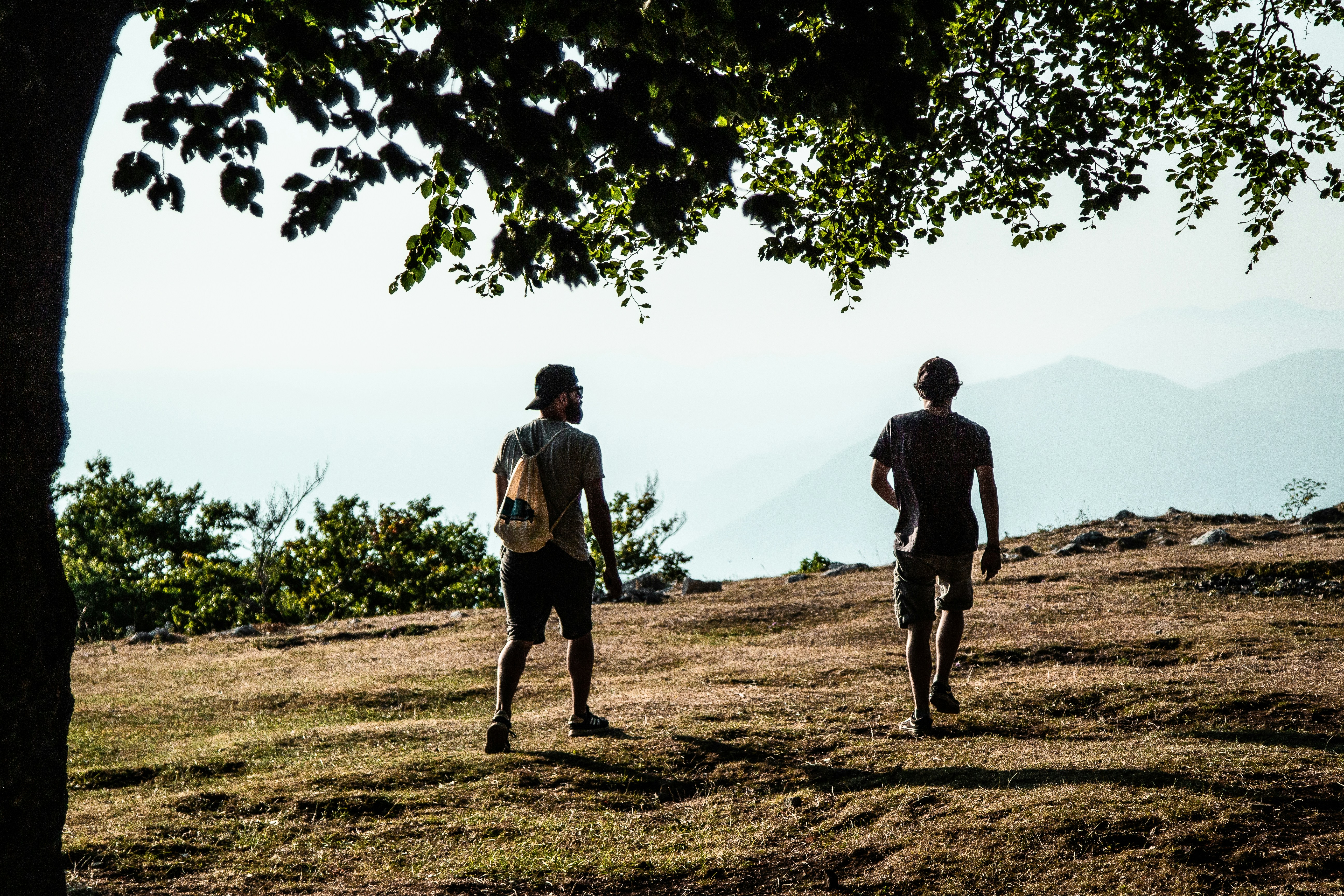 two men walking on a dirt path