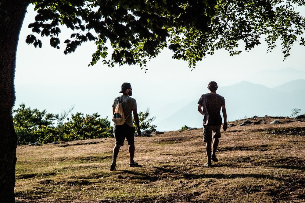 two men walking on a dirt path