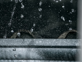 photorealistic image of industrial water extraction equipment in action on a wet hardwood floor, subtle reflections and professional lighting