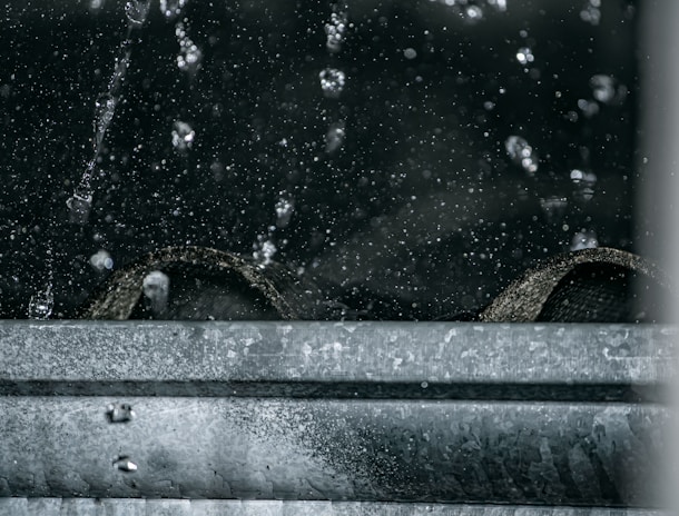 photorealistic image of industrial water extraction equipment in action on a wet hardwood floor, subtle reflections and professional lighting