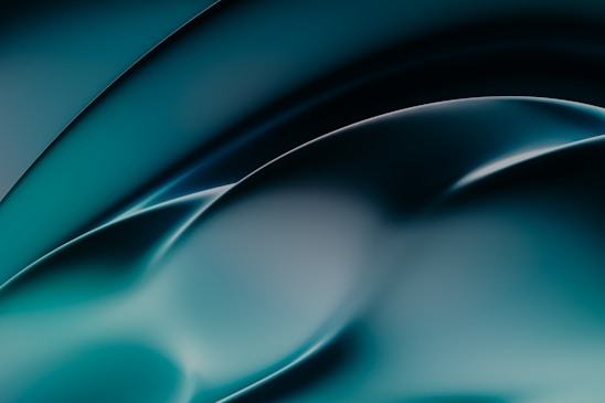 A smooth, abstract design featuring flowing curves and gradients. The image primarily uses shades of teal and black, creating a fluid and dynamic visual effect.