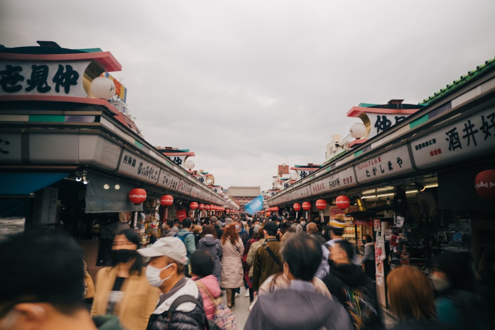 a crowd of people walking in a street