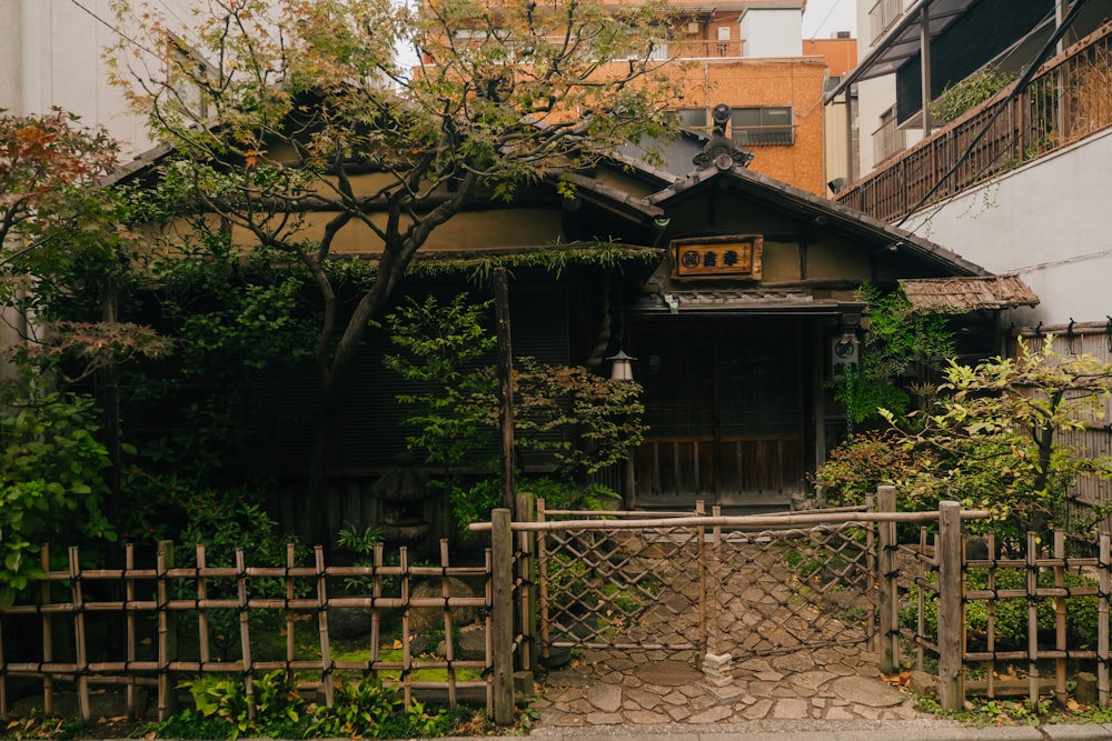 a house with a fence and trees around it