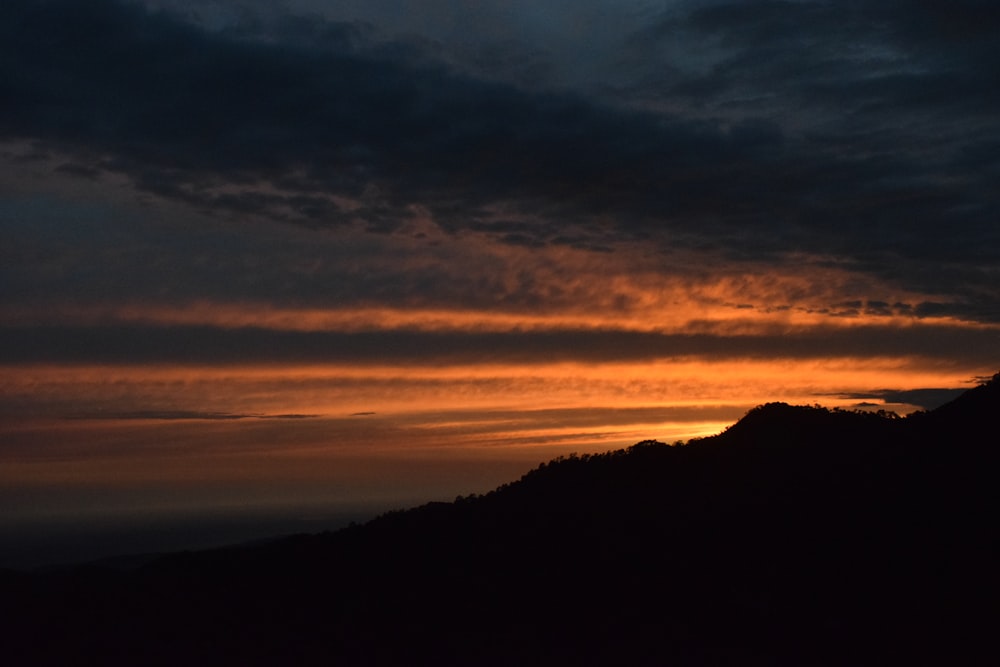 a sunset over a mountain