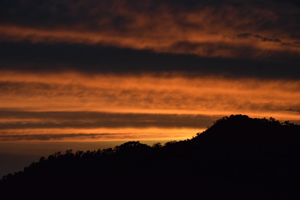 a sunset over a mountain