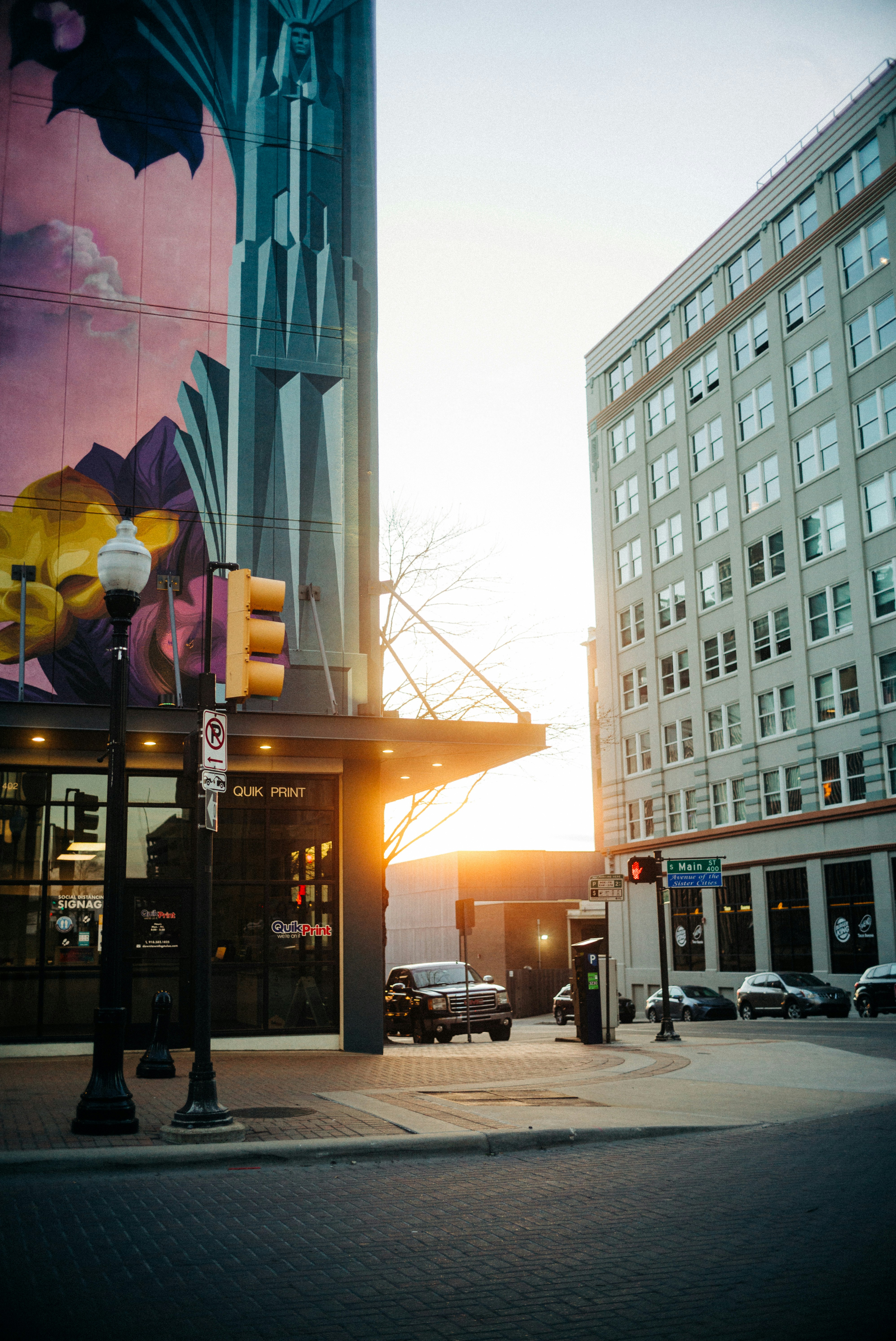 a street with a building with a mural on it
