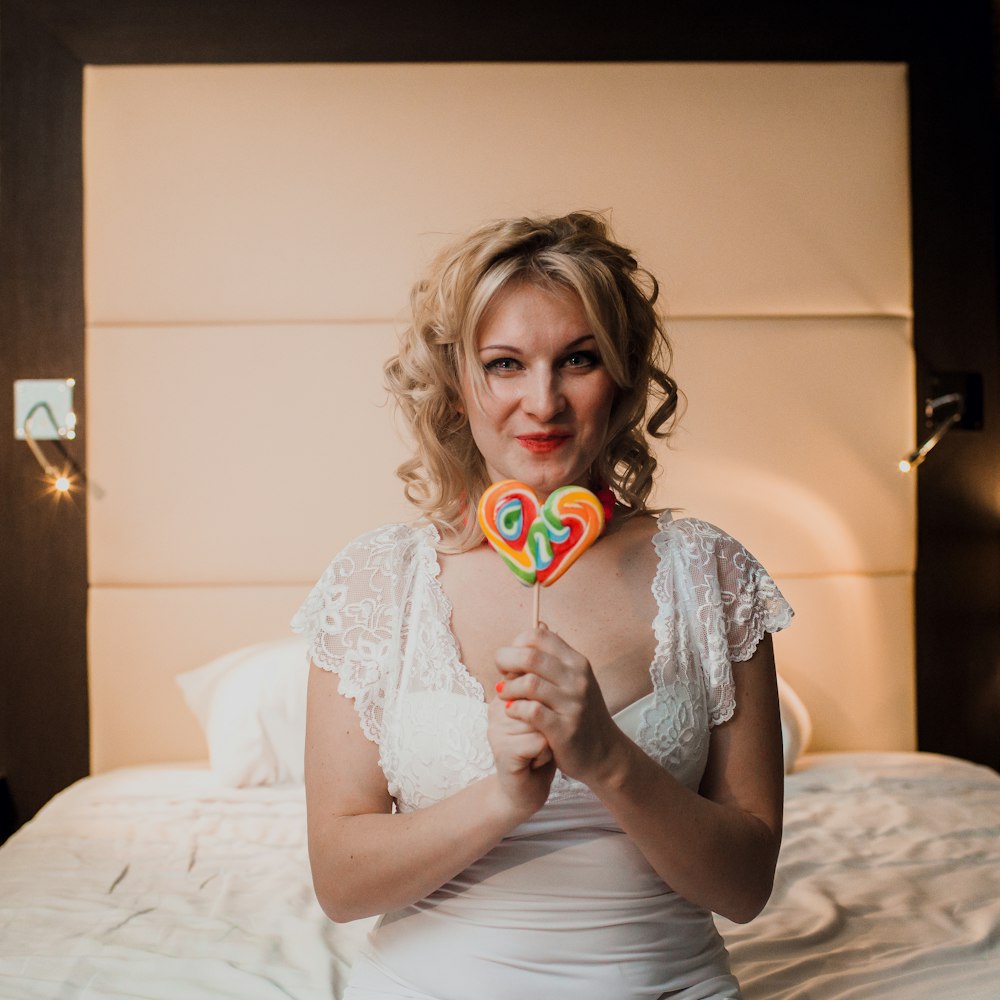 a woman holding a lollipop