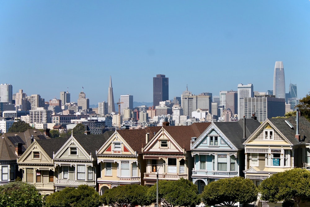 a group of houses with a city in the background