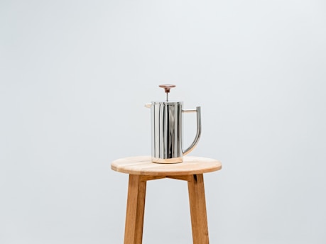 a metal faucet on a stool