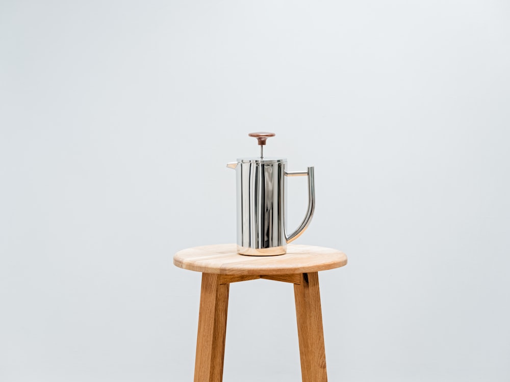 a metal faucet on a stool