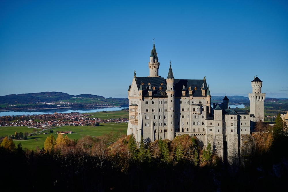 a castle on a hill with Neuschwanstein Castle in the background