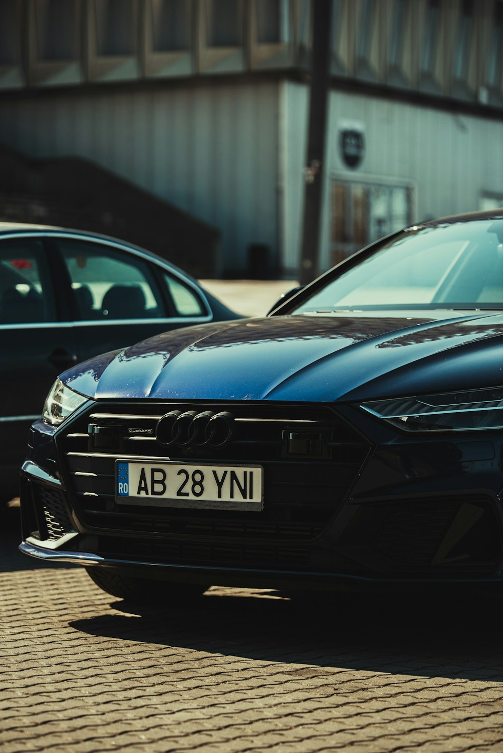 a black car parked on a brick road