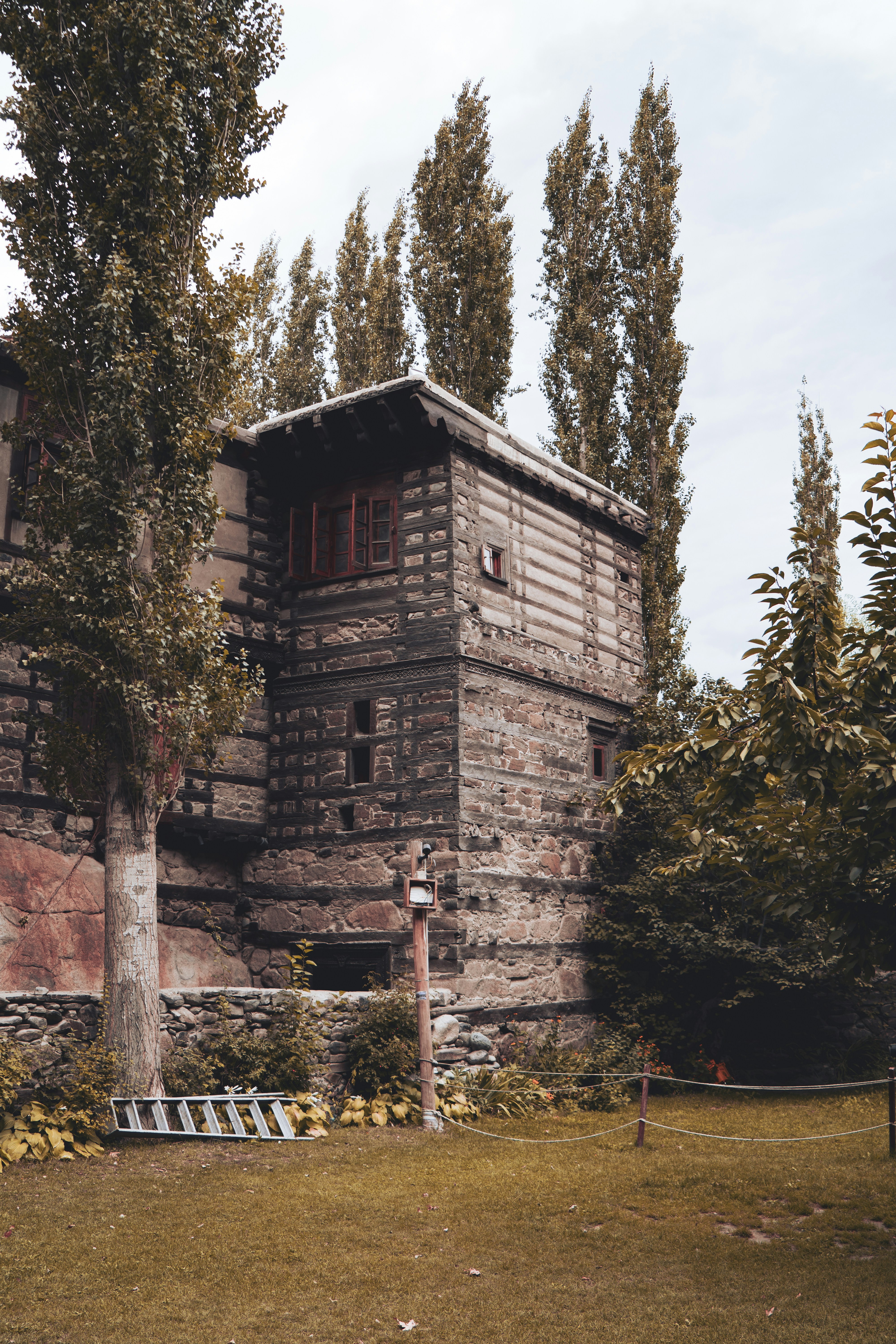 a brick building with trees around it