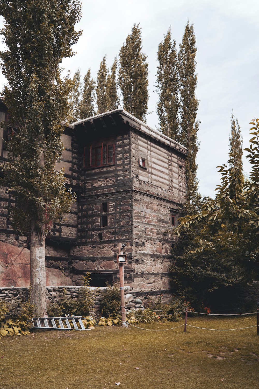 a brick building with trees around it