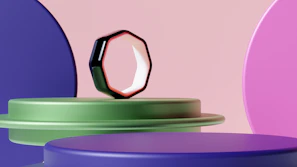 An elegant ring with geometric design displayed on a minimalist wooden stand against a soft fabric backdrop.