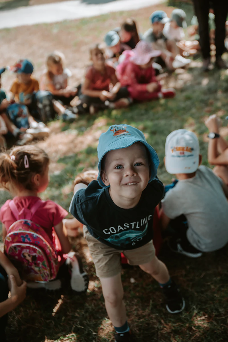 A group of campers laughing together arm in arm