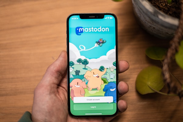 A hand (not that of the author!) holding a smartphone showing the Mastodon app.
