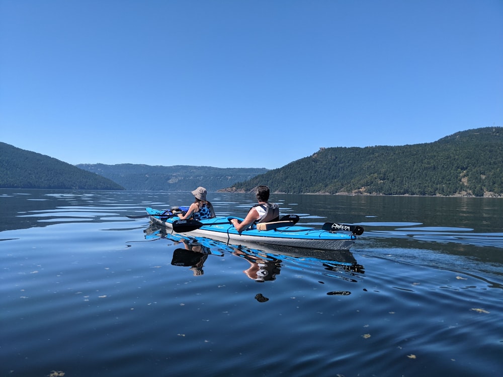 two people in a canoe on a lake