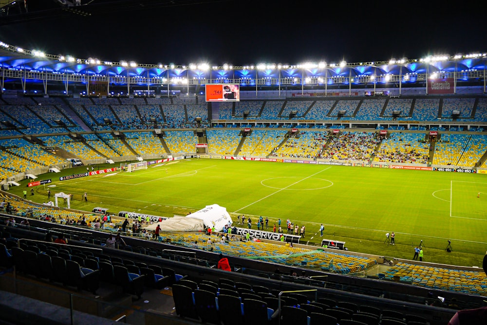 a football field with a crowd watching