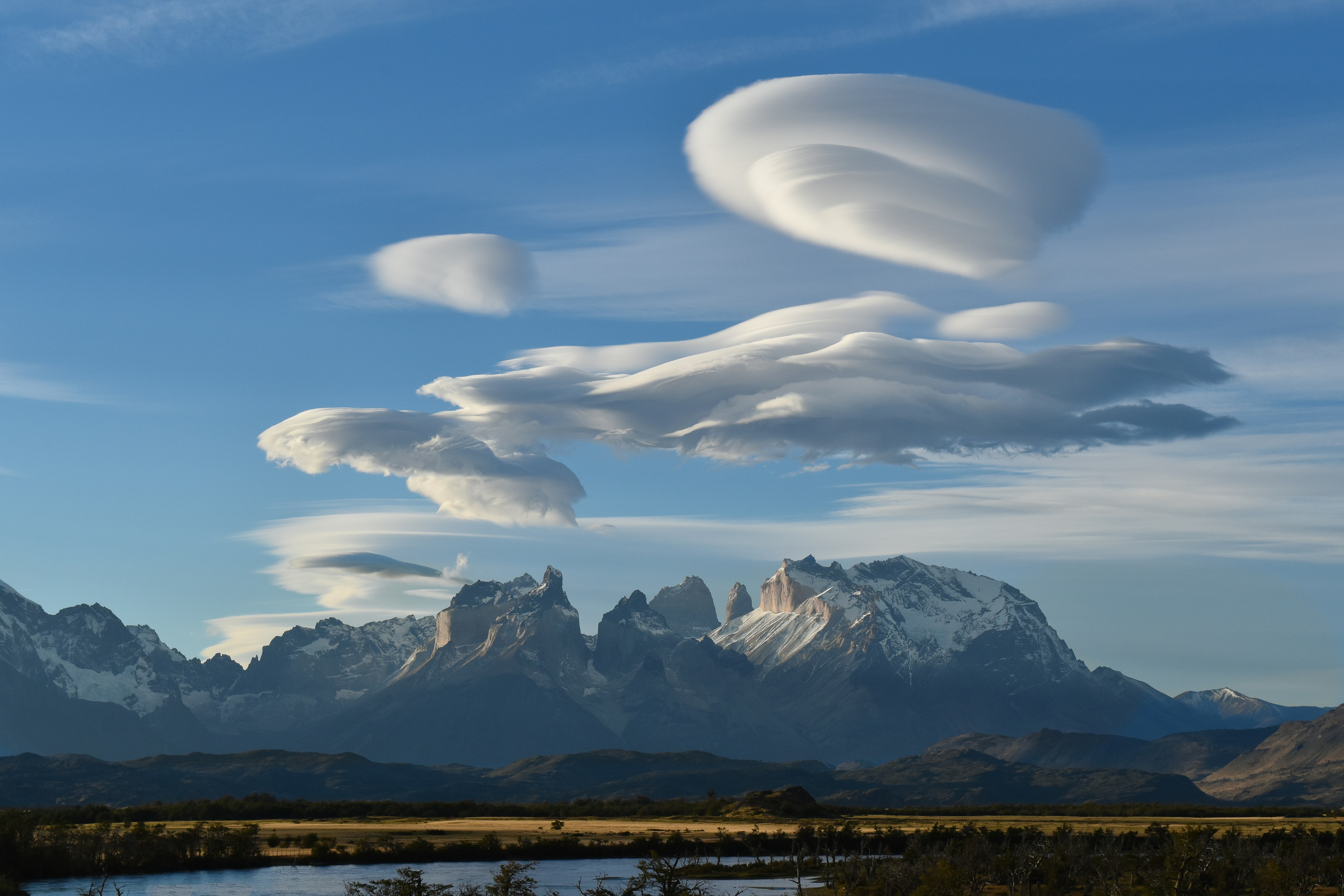 a landscape with mountains and clouds
