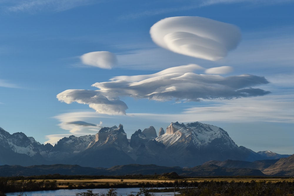 a landscape with mountains and clouds