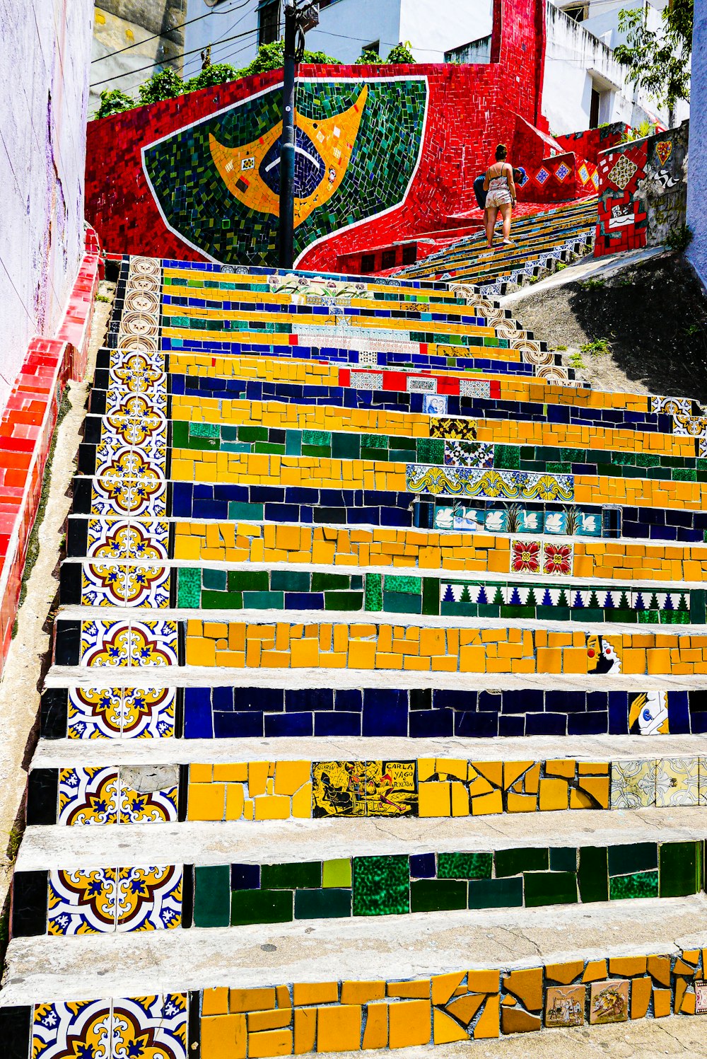 a colorful wall with a person standing on it